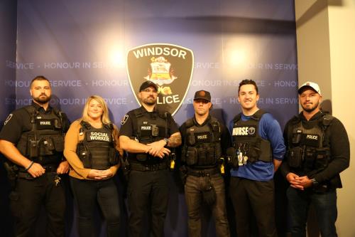 Group photo of police officers, nurses, and social workers.